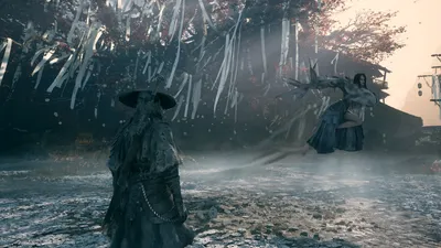 A broad-hatted figure stands over a kneeling figure in a misty bamboo grove.