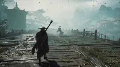 A lone traveller walks a wet stone road toward mist-shrouded karst peaks and a pagoda.